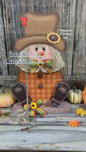 Load and play video in Gallery viewer, Scarecrow, Pumpkin centerpiece, Fall wood decor, Thanksgiving porch decor, Primitive Scarecrow on pumpkin sign, Fall arrangement, Halloween
